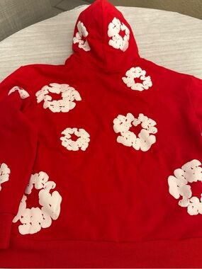 Red Denim Tears hoodie with White Floral Ring Prints